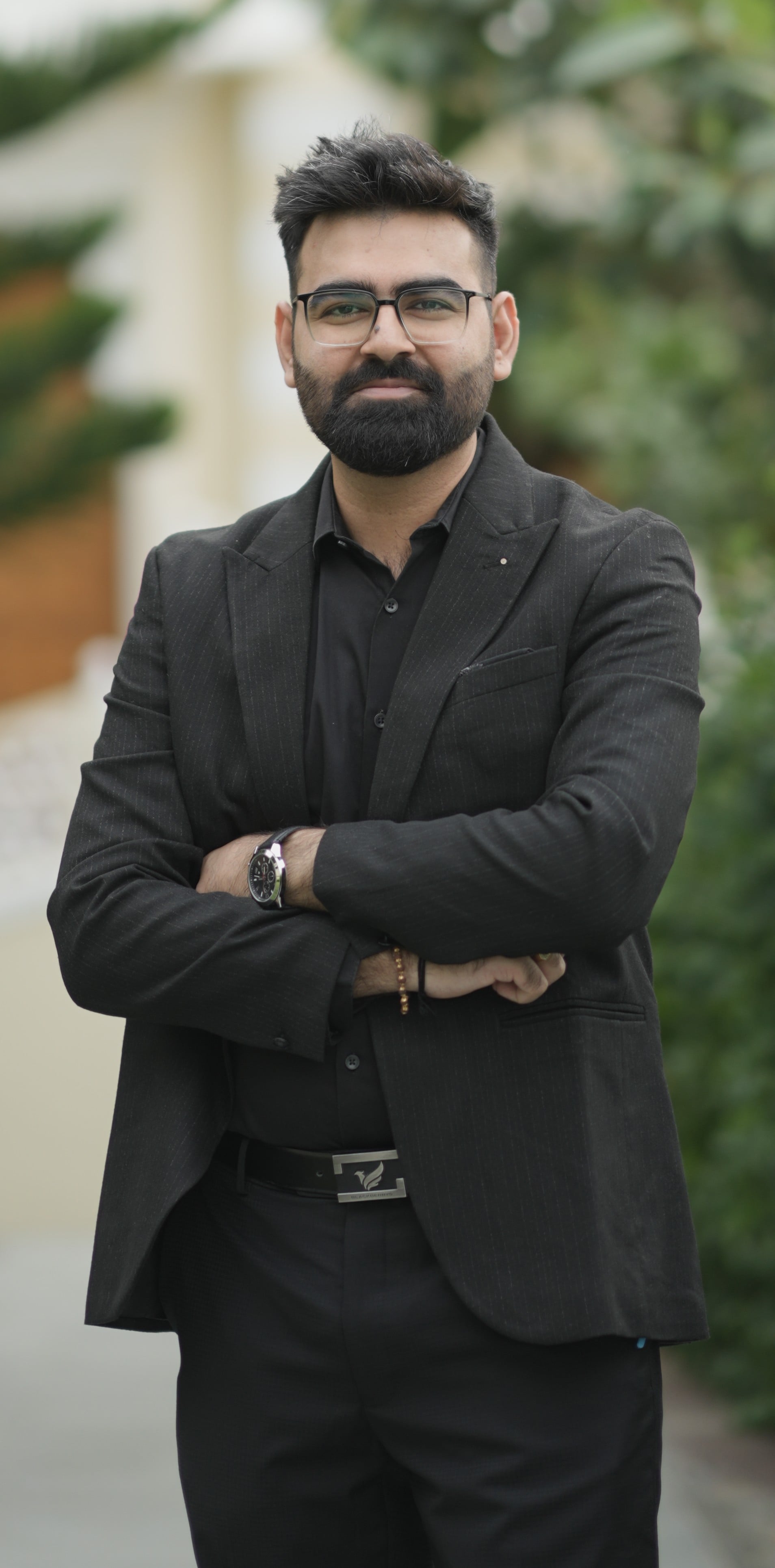 Darshan Ahuja, B2B performance marketer, professional headshot in formal attire, dark studio background with dramatic lighting